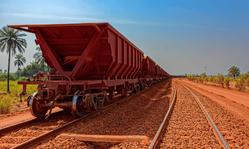A freight train carrying bauxite in railway carriages for transhipment in Africa.