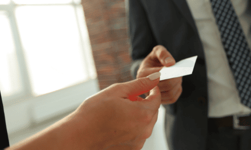A man and woman exchanging a business card
