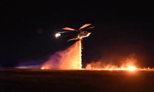 Aerial firefighting helicopter conducting firefighting operations at night