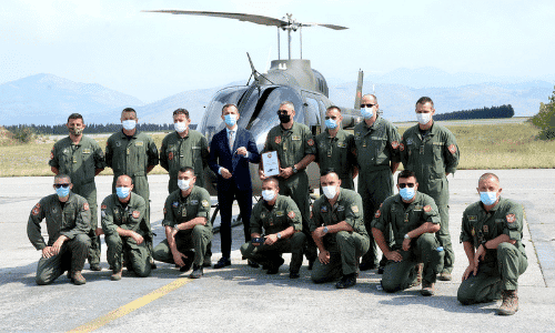 Image of Bell 505 Jet Ranger X helicopter in the background with servicemen of Montenegro’s Air Force in the foreground