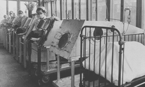 Patients on iron lungs, an early version of ventilators, to help them breathe after polio paralyzed their respiratory and throat muscles