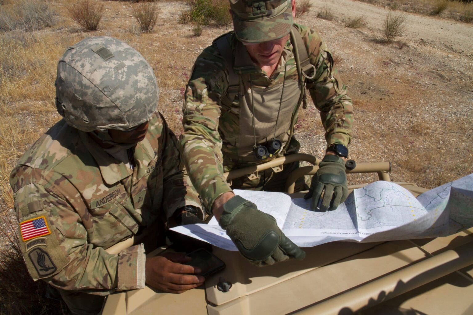 FORT HUNTER LIGGETT-- U.S. Army Reserve Soldier Sgt. Anthony Anderson (Left), 91st Training Division, Fort Hunter Liggett, California and Brig. Gen. W. Shane Buzza, Commanding General, 91st Training Division, Fort Hunter Liggett, California review a map to determine whether a units placement will hinder unit performance during CSTX 91-18-01, at Fort Hunter Liggett, California, July 12, 2018. CSTX 91-18-01 is a Combat Support Training Exercise that ensures America’s Army Reserve units and Soldiers are trained and ready to deploy and bring capable, combat-ready, and lethal firepower in support of the Army and our joint partners anywhere in the world.