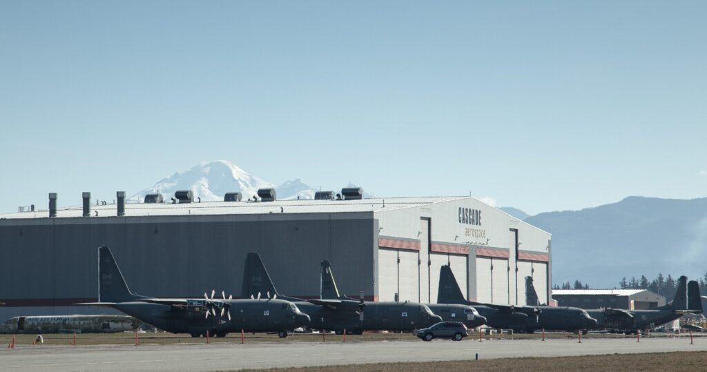 Ouside of hanger for Cascade Aerospace with Hercules aircraft in foreground