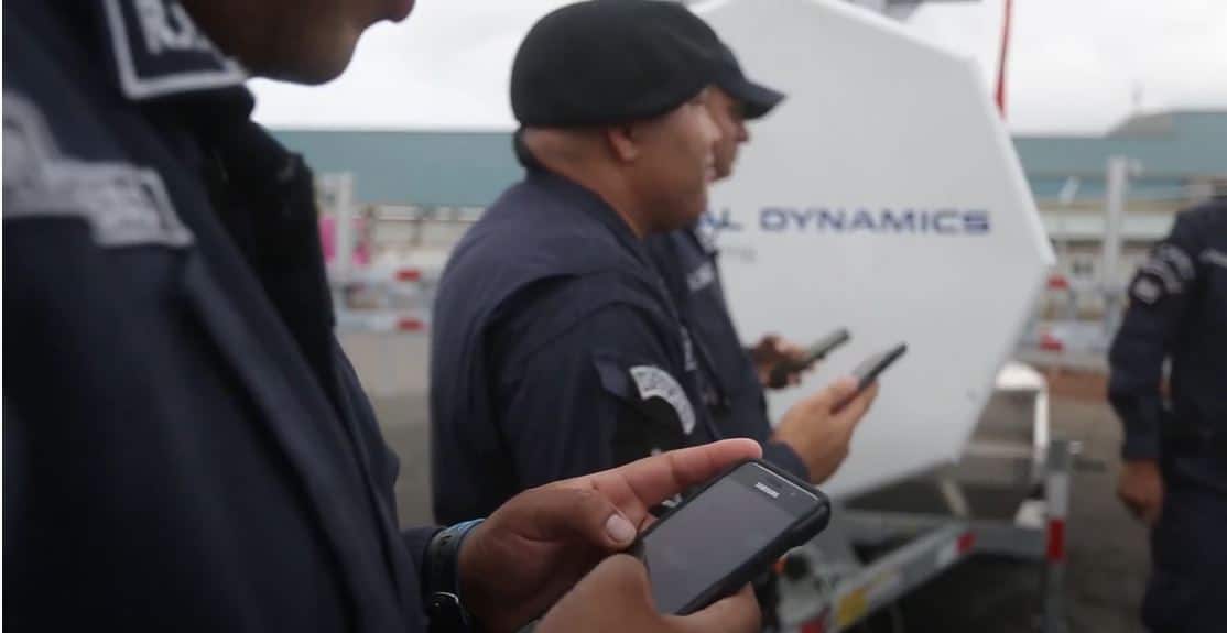 First responders with walkie talkies with General Dynamics logo in background