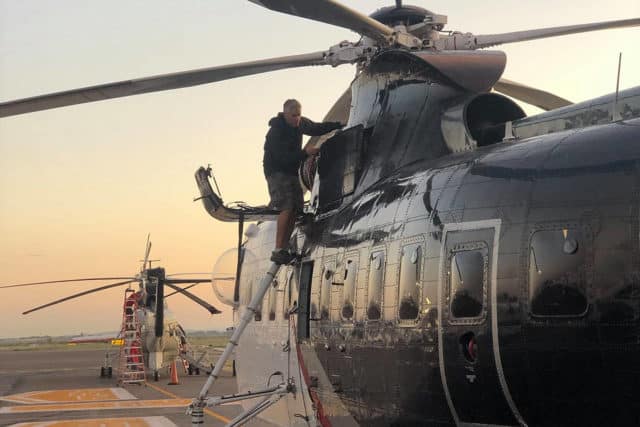 Crew members from Coulson Aviation prepare two Sikorsky S-61 helicopters at an airfield in Los Leones, Chihuahua, Mexico for an overseas flight to Bolivia, where they will be tasked to fight forest fires in the Amazon rainforests.