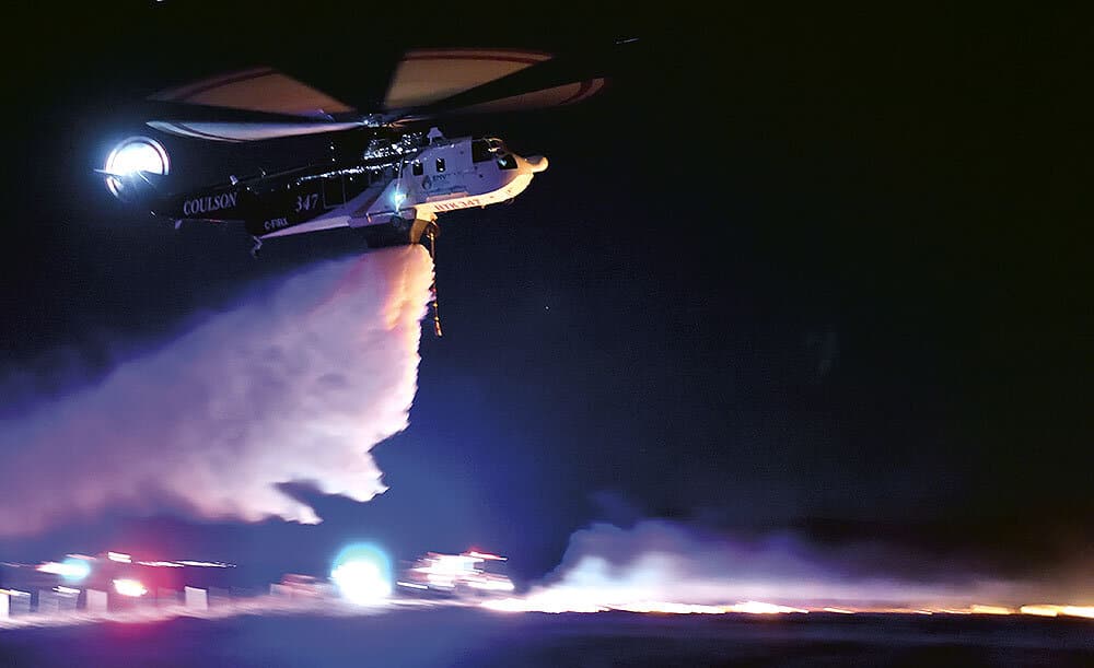 Coulson helicopter spraying water at night