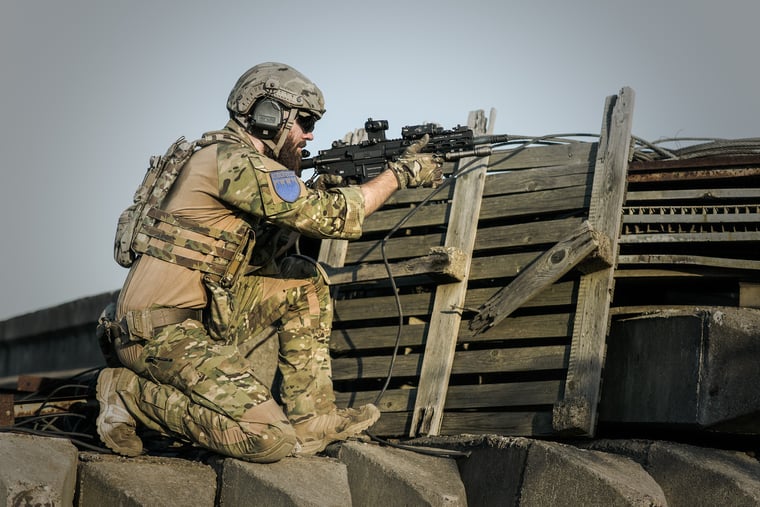 Soldier pointing a gun in military practice session